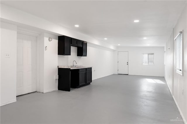 20538 Rio Rancho Rd, Harlingen, TX 78552 - kitchen featuring dark cabinets, recessed lighting, light countertops, and finished concrete floors