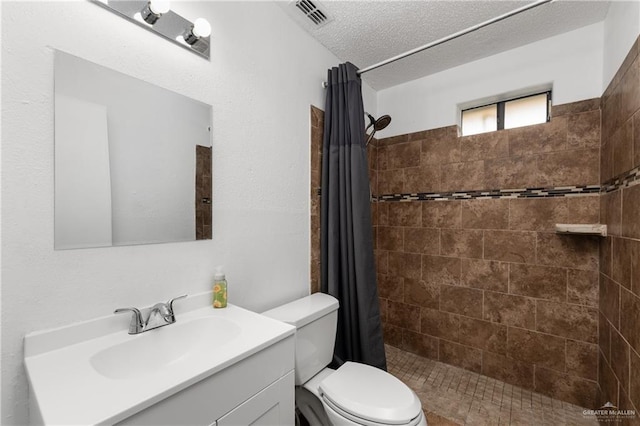 20538 Rio Rancho Rd, Harlingen, TX 78552 - full bathroom featuring vanity, tiled shower, and a textured ceiling