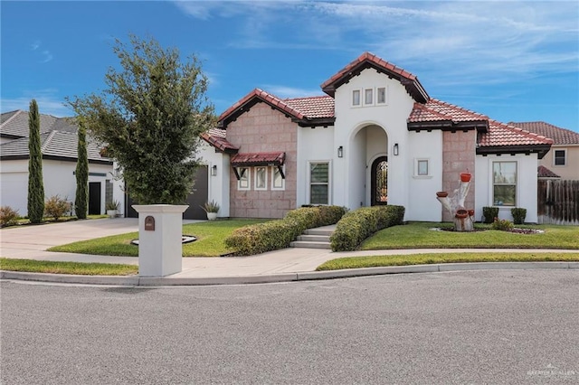 3408 Madison Ave, Edinburg, TX 78539 - mediterranean / spanish house featuring driveway, a tile roof, stucco siding, and an attached garage