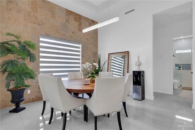 3408 Madison Ave, Edinburg, TX 78539 - dining area featuring baseboards and a towering ceiling