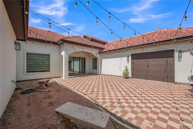 3408 Madison Ave, Edinburg, TX 78539 - rear view of property with a tile roof, stucco siding, and an attached garage