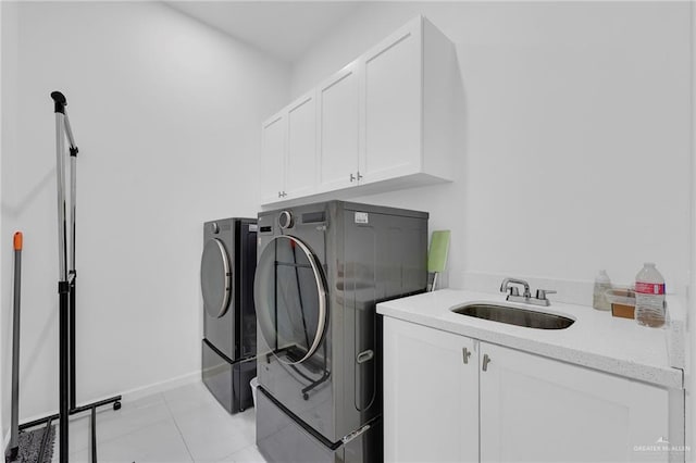 3408 Madison Ave, Edinburg, TX 78539 - laundry room featuring washer and dryer, cabinet space, and light tile patterned floors