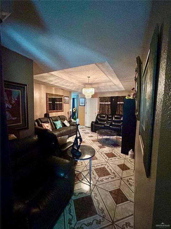 living room with a raised ceiling, light tile patterned floors, a textured ceiling, and a notable chandelier