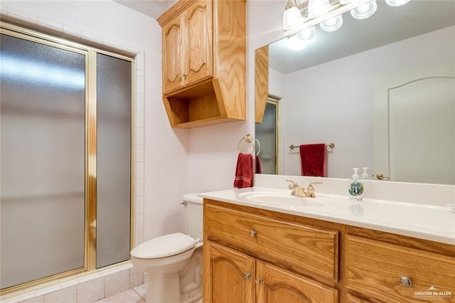 bathroom featuring vanity, toilet, and an enclosed shower