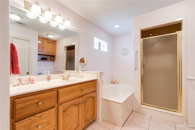 bathroom with tile patterned floors, plus walk in shower, and vanity