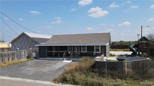 view of front of home featuring a patio area and a playground