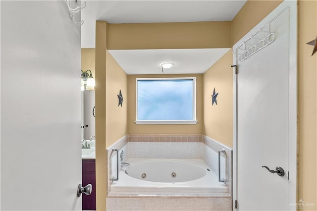 bathroom with a jetted tub and vanity