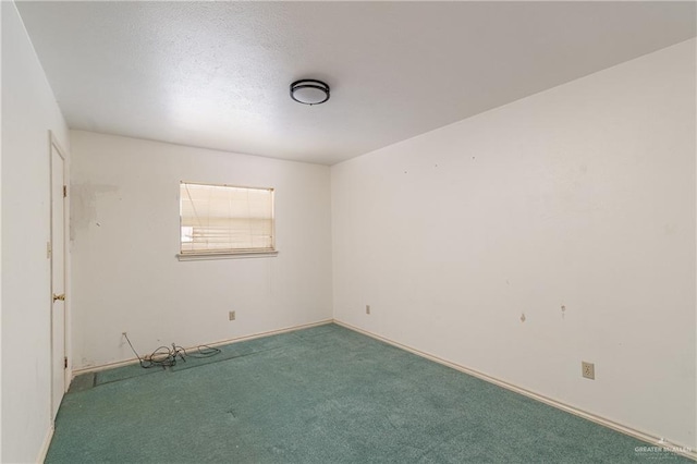 carpeted empty room with baseboards