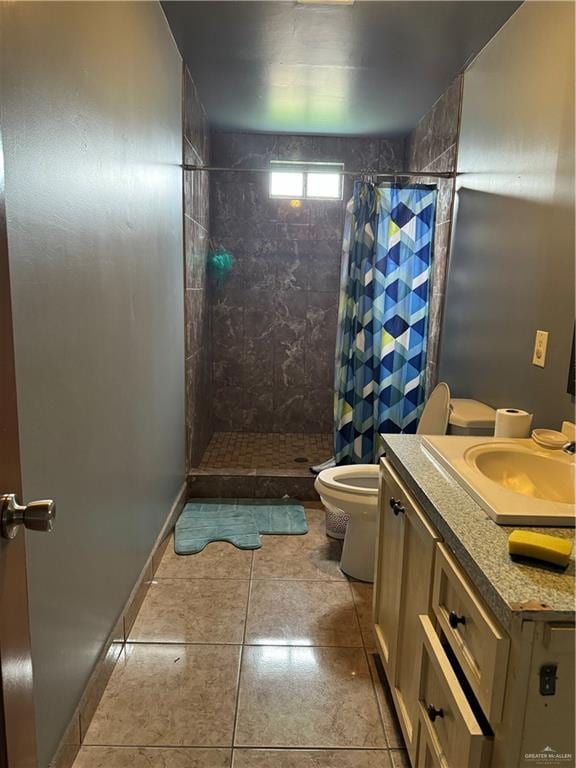 4512 Devon St, Mercedes, TX 78570 - bathroom featuring toilet, tile patterned floors, tiled shower, and vanity
