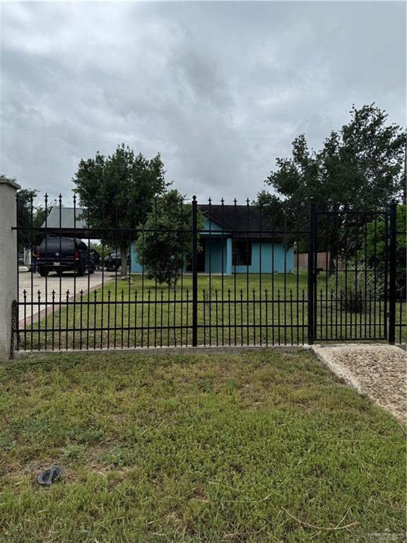 4512 Devon St, Mercedes, TX 78570 - view of gate featuring fence and a lawn