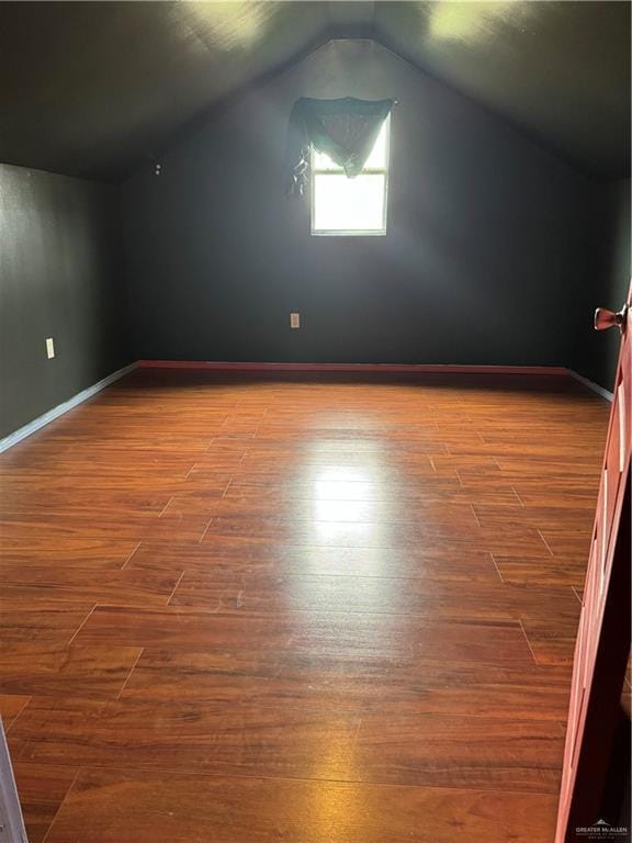 4512 Devon St, Mercedes, TX 78570 - additional living space featuring baseboards, wood finished floors, and lofted ceiling