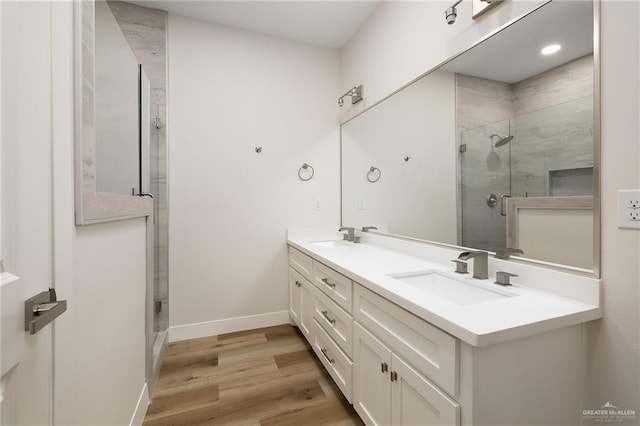 bathroom featuring vanity, hardwood / wood-style floors, and an enclosed shower