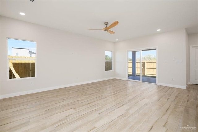 spare room featuring ceiling fan and light hardwood / wood-style floors