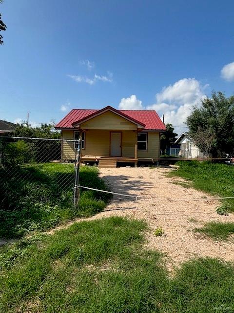 back of property featuring covered porch