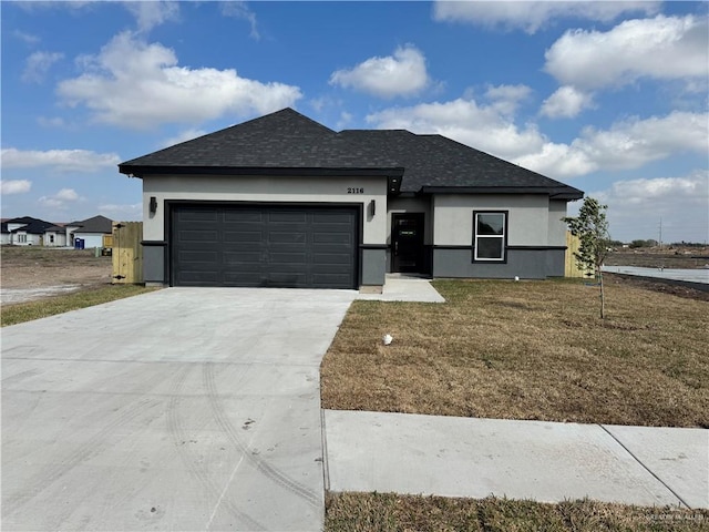 view of front of property with a garage and a front yard