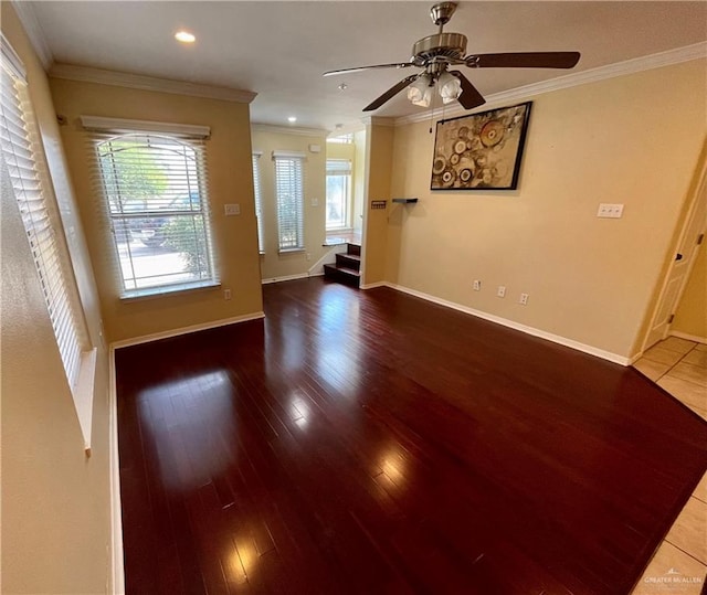 unfurnished living room featuring hardwood / wood-style floors, ceiling fan, and crown molding