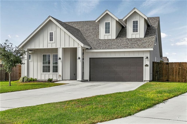 view of front of home with a front yard and a garage