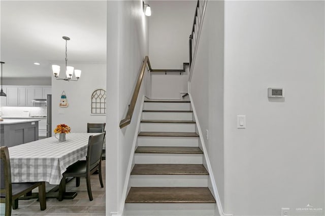 stairs with an inviting chandelier