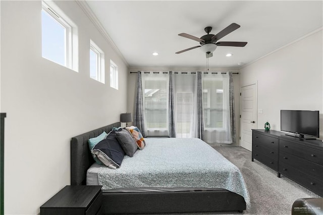 carpeted bedroom with ceiling fan and crown molding