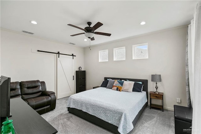 carpeted bedroom featuring ceiling fan, a barn door, and crown molding