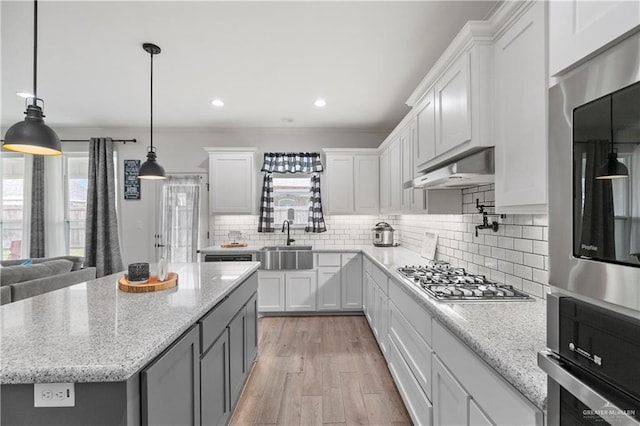 kitchen featuring white cabinets, plenty of natural light, and ventilation hood