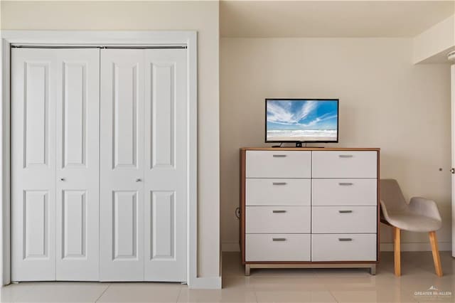 unfurnished bedroom with a closet and light tile patterned floors