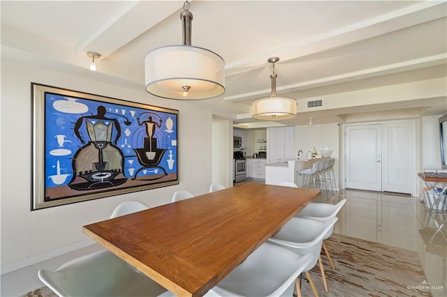 6300 Padre Blvd Unit 901, South Padre Island, TX 78597 - tiled dining area with beamed ceiling and baseboards