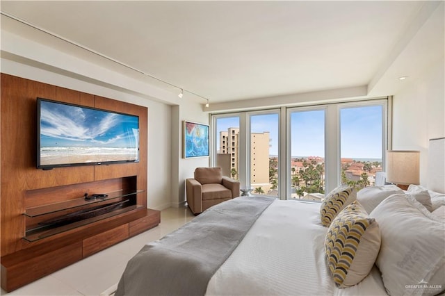 6300 Padre Blvd Unit 901, South Padre Island, TX 78597 - bedroom with tile patterned floors and rail lighting
