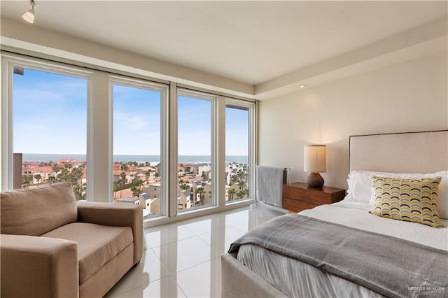 bedroom with multiple windows and light tile patterned flooring