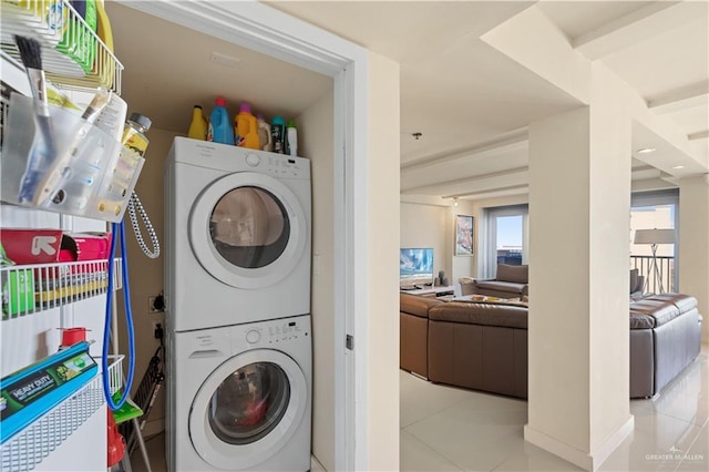 6300 Padre Blvd Unit 901, South Padre Island, TX 78597 - laundry room featuring stacked washer / drying machine, tile patterned flooring, and plenty of natural light