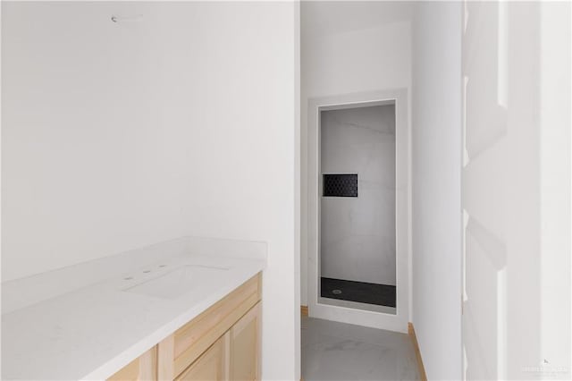 bathroom with a shower and vanity