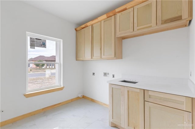 clothes washing area featuring cabinets and washer hookup