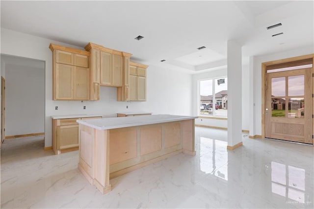 kitchen with light brown cabinetry and a kitchen island