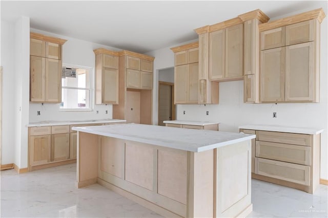 kitchen featuring a center island and light brown cabinets