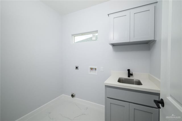 laundry room with hookup for an electric dryer, hookup for a washing machine, cabinets, and sink