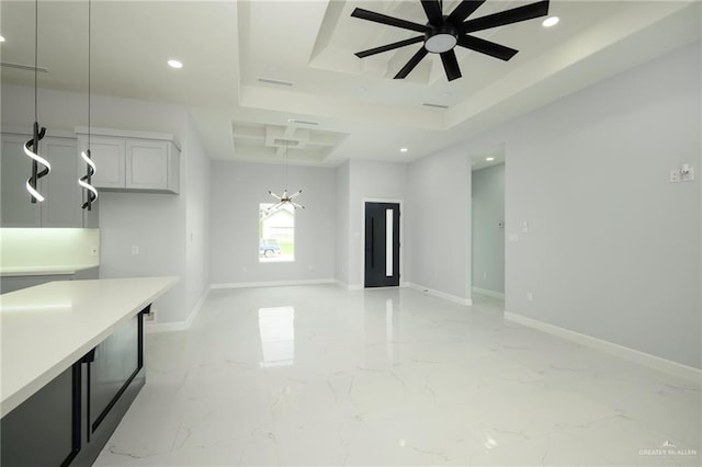 spare room with a raised ceiling and ceiling fan