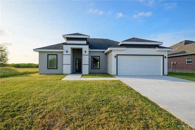 prairie-style home with a garage and a front lawn