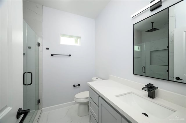 bathroom with vanity, toilet, and a shower with door