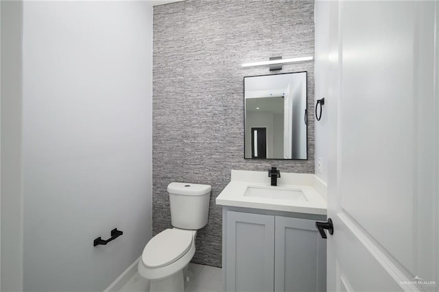 bathroom featuring tile patterned floors, vanity, and toilet