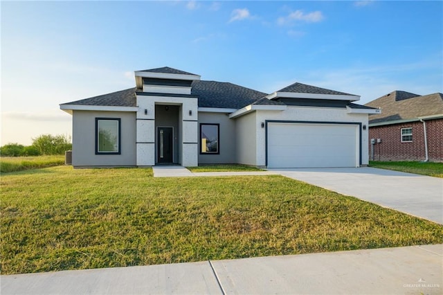 prairie-style home featuring a front yard and a garage