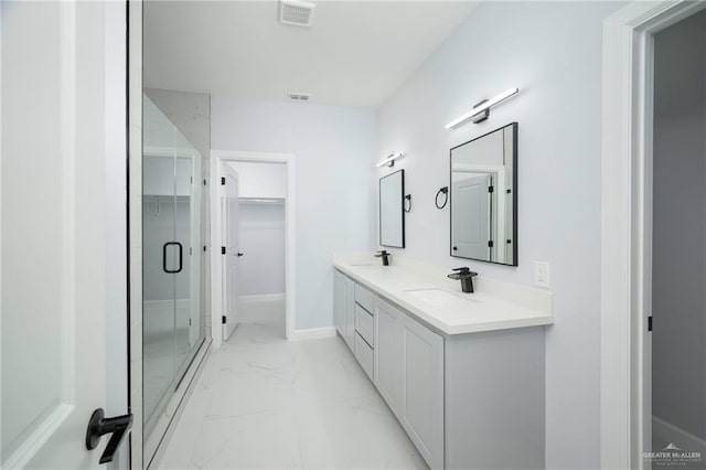 bathroom with vanity and a shower with shower door