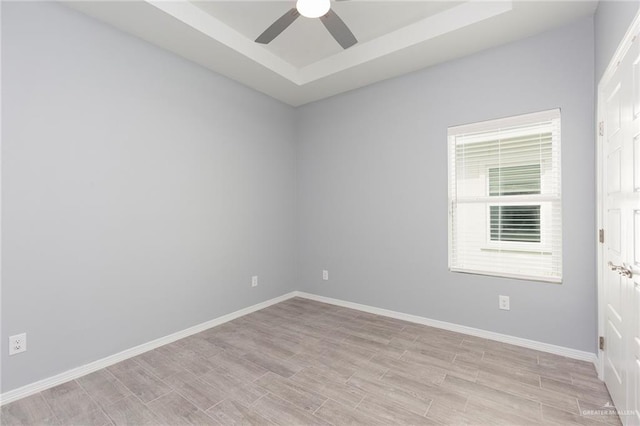 spare room featuring light hardwood / wood-style flooring and ceiling fan