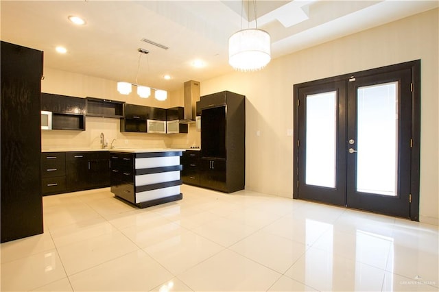 kitchen featuring pendant lighting, ventilation hood, and light tile patterned floors