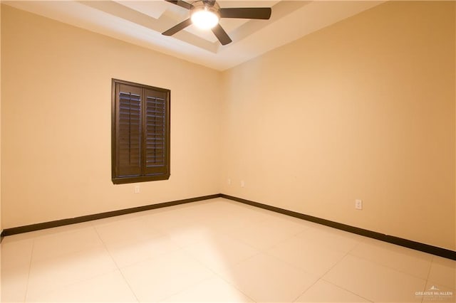 tiled spare room featuring ceiling fan