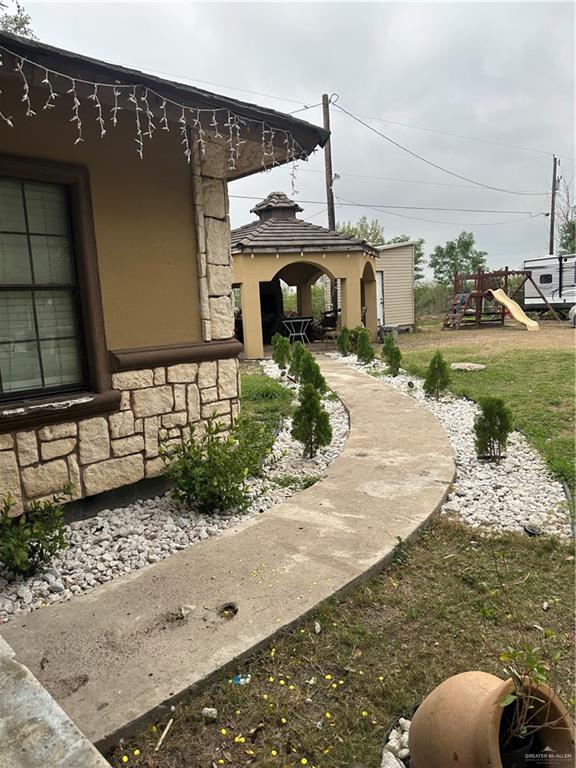 view of yard with a gazebo and a playground