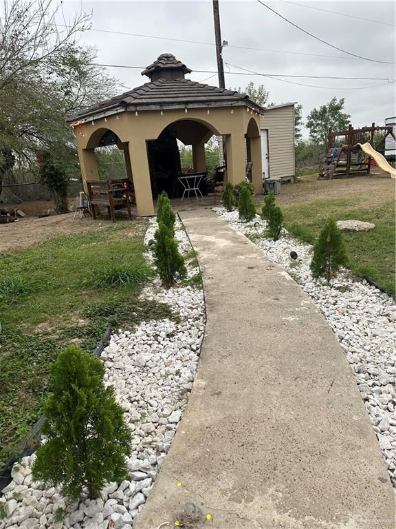 view of yard featuring a gazebo and a playground