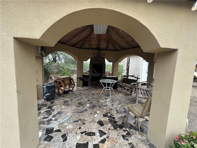 view of patio with exterior fireplace