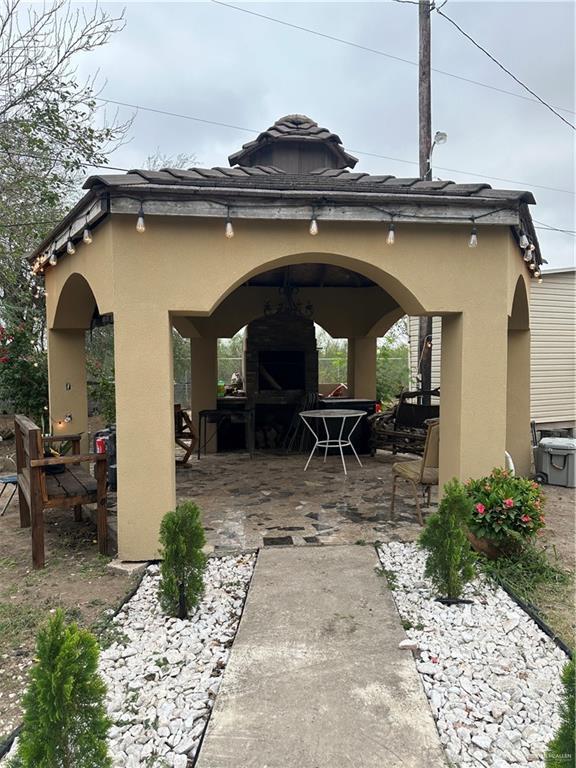 exterior space featuring an outdoor fireplace