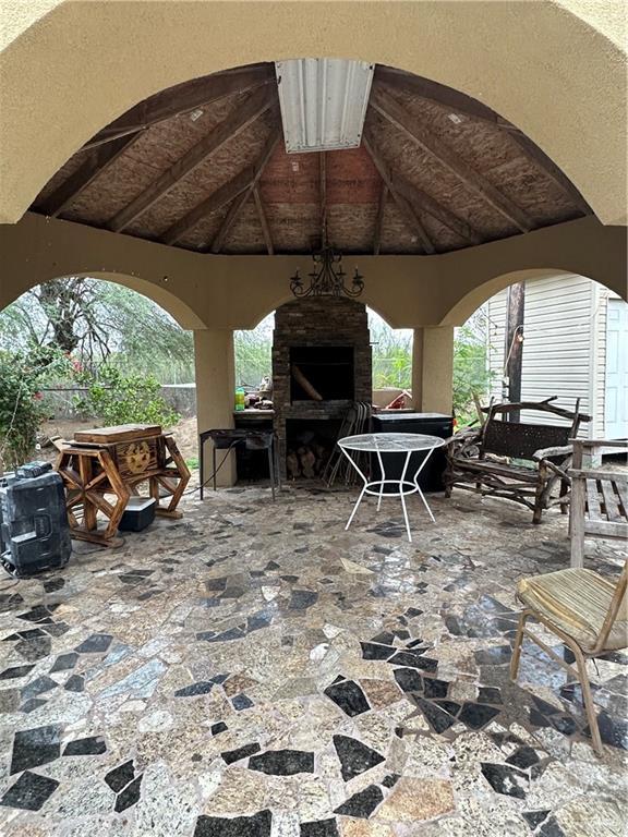 view of patio with an outdoor stone fireplace