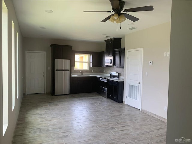 kitchen featuring sink, backsplash, ceiling fan, and appliances with stainless steel finishes